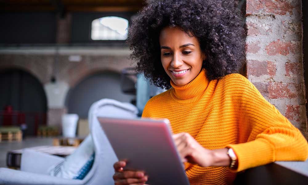 woman looking at finances on tablet device
