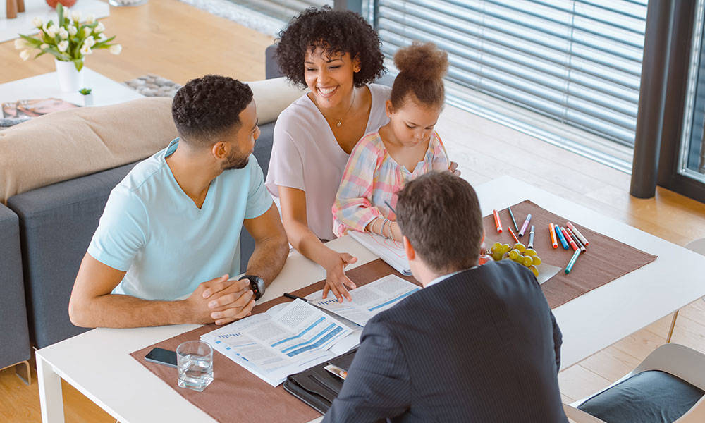 married couple and daughter consulting with financial advisor