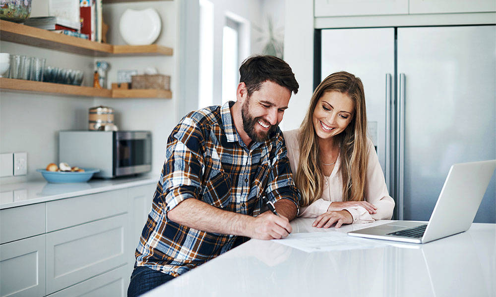 couple going over financial plan in kitchen