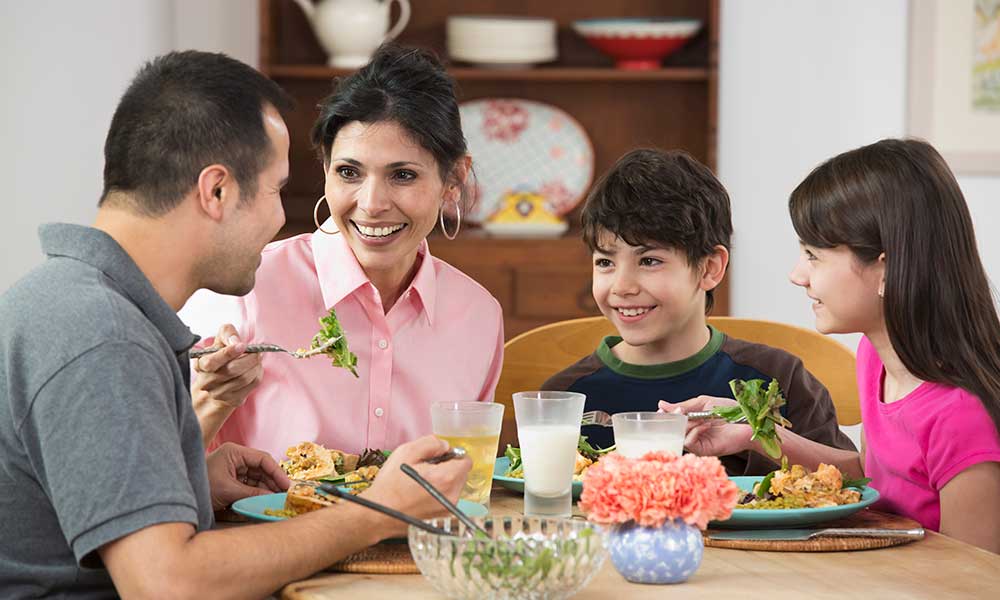 family of 4 sitting around the dinner table
