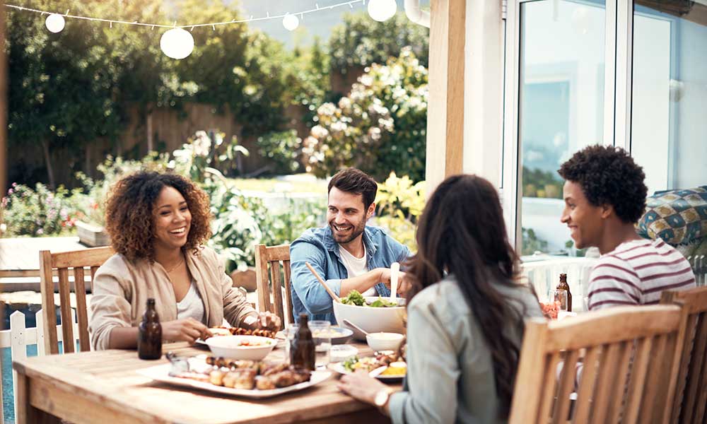 group of friends having a meal together outdoors