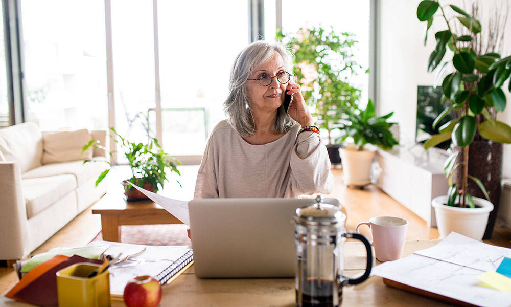 older woman working at home on laptop