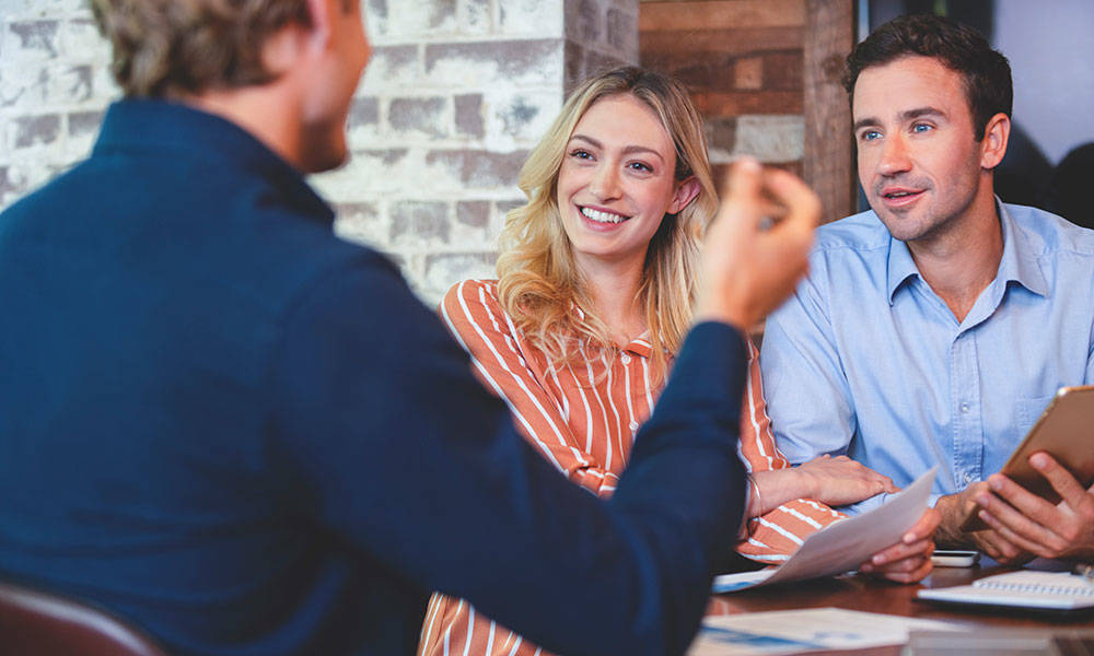 young couple meeting with financial advisor