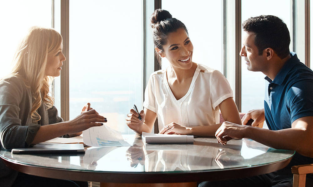 young couple meeting with a financial planner in office