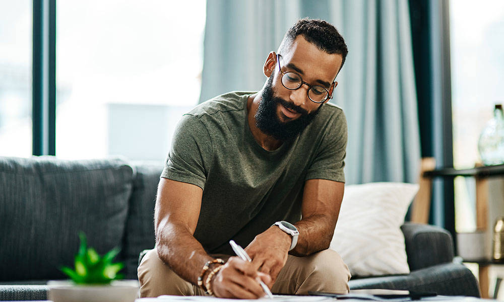 man at home working on his finances