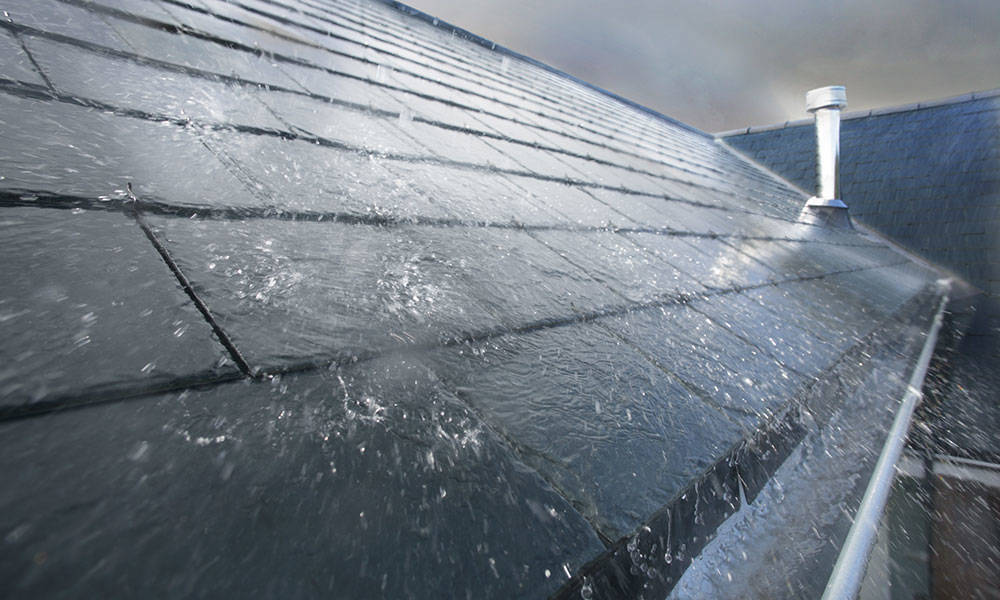 rain falling down on roof on stormy day