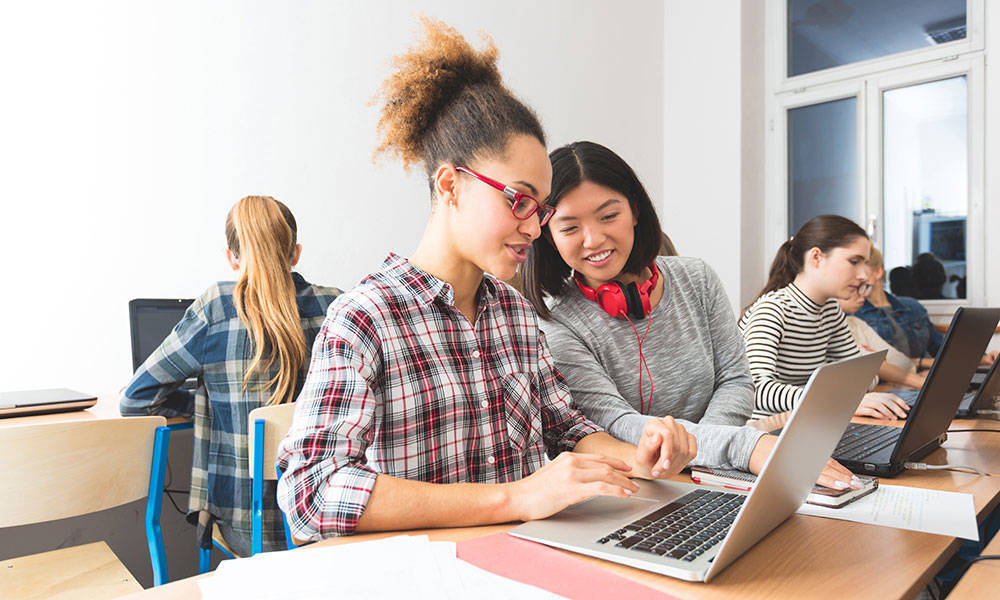 college students working together to learn computer programming