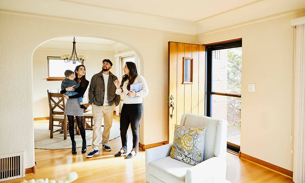 family looking over house with realtor