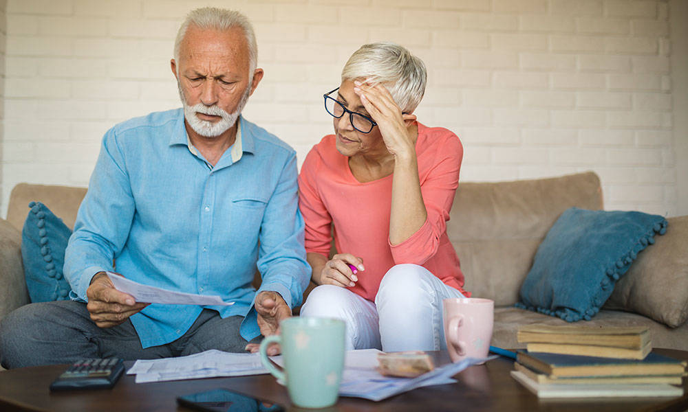 senior couple brainstorming the solution to a financial problem