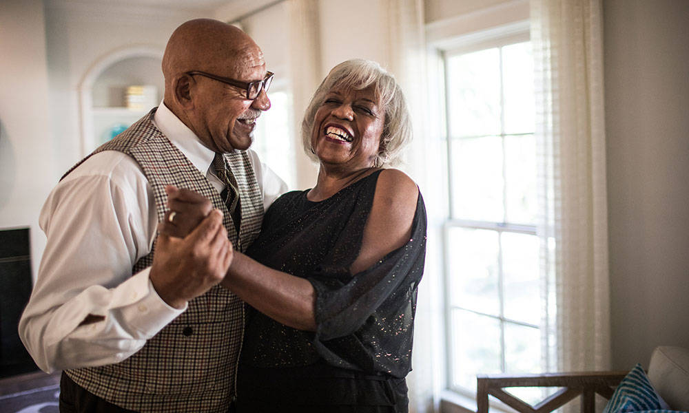senior couple laughing with each other at home