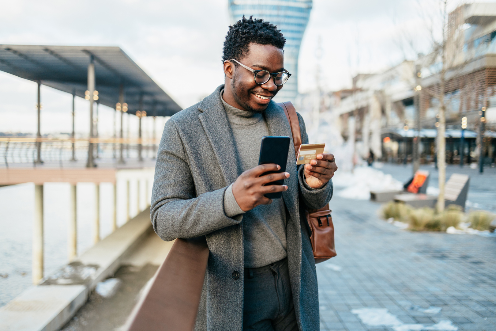 Man using debit card on mobile phone