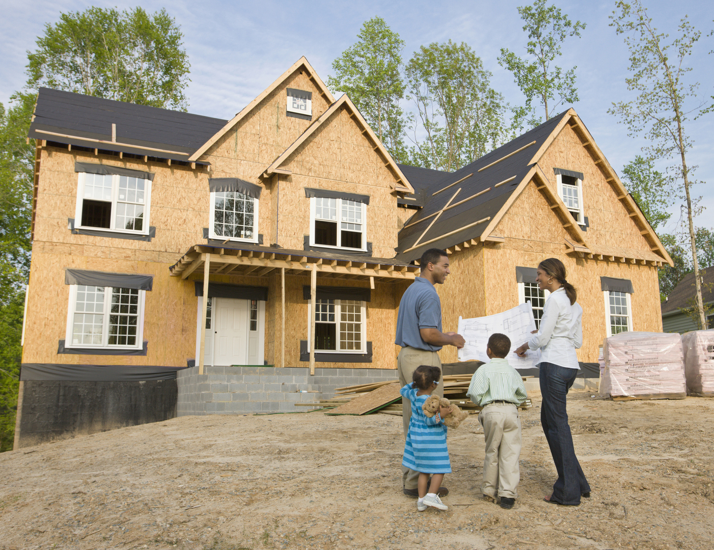Family looking at their newly built home