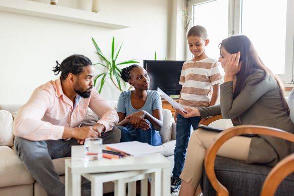 Family meeting with financial advisor at home.