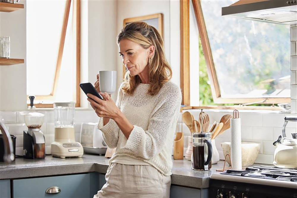Investment Path - Woman Drinking Coffee and Banking on Phone
