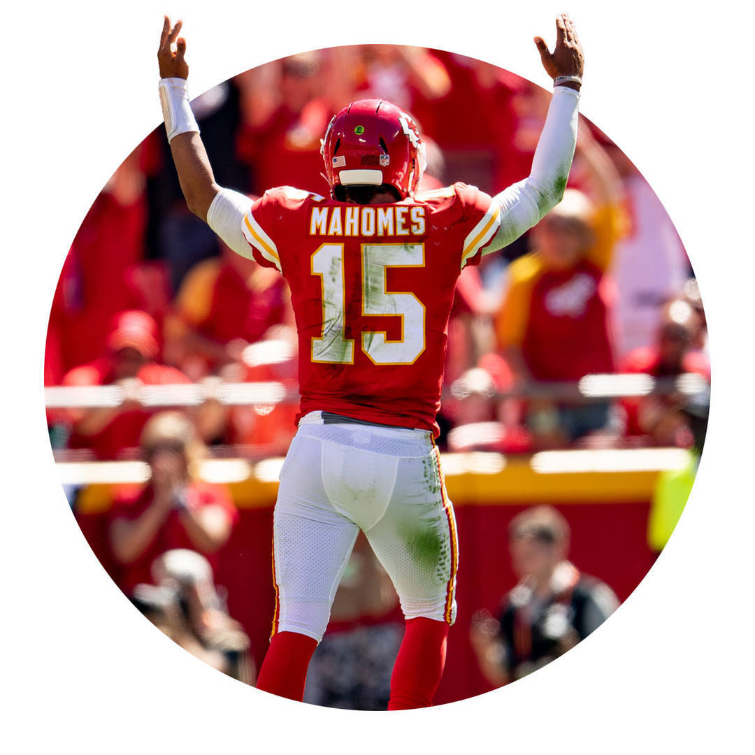 Patrick Mahomes with raised arms signaling touchdown.