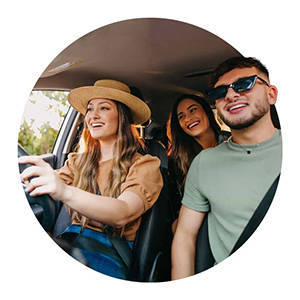 Three friends driving in car listening to music.