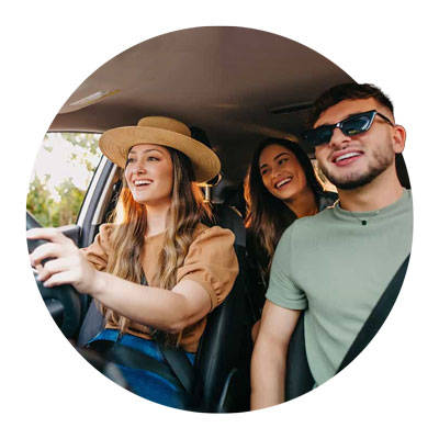 Three friends driving in the car listening to music.