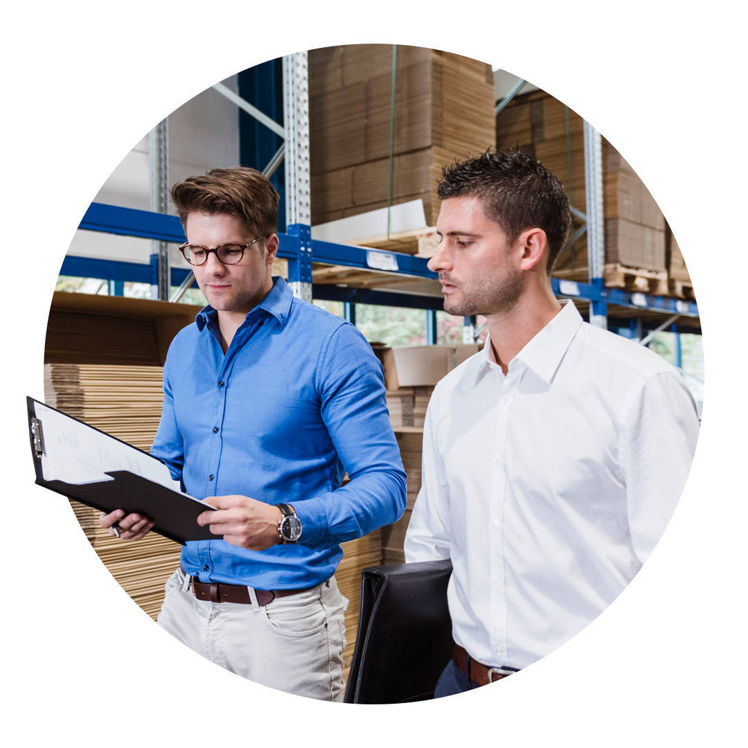 Two businessmen having a meeting in the company warehouse.