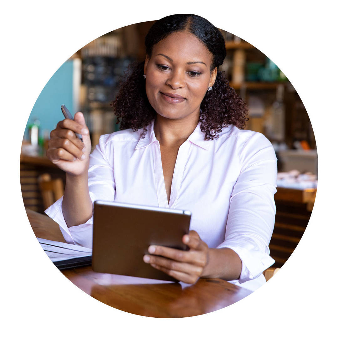 Business owner reviewing finances on a tablet.
