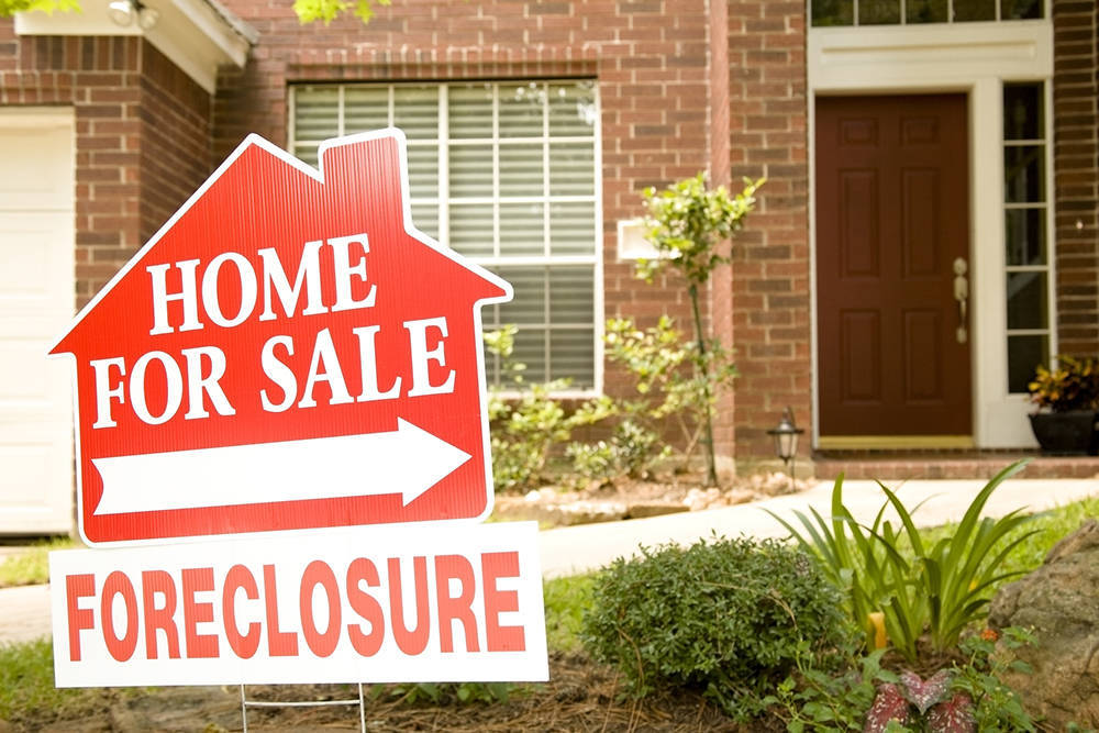 Foreclosure sign in front of a house