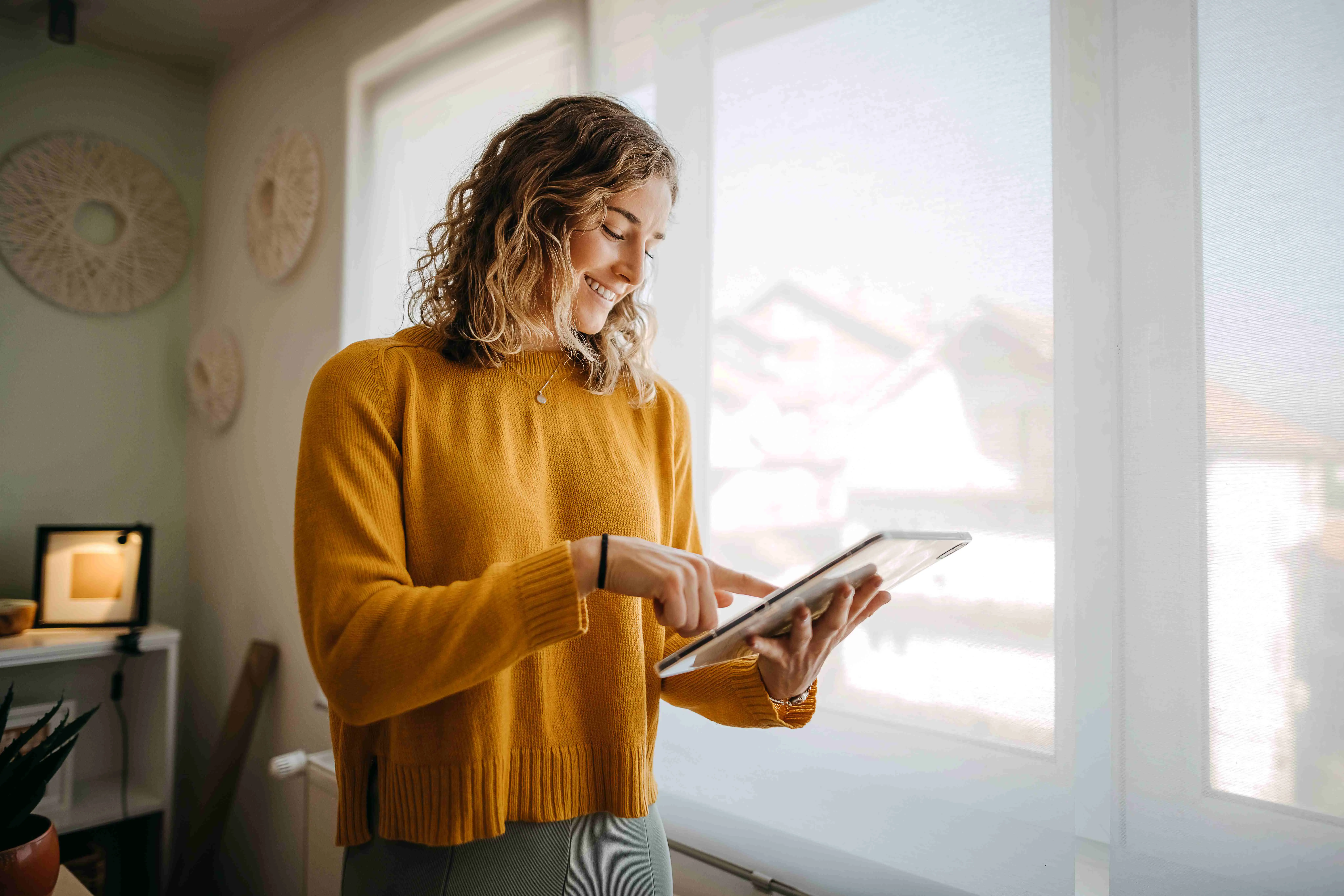  Businesswoman using a digital tablet while working from home